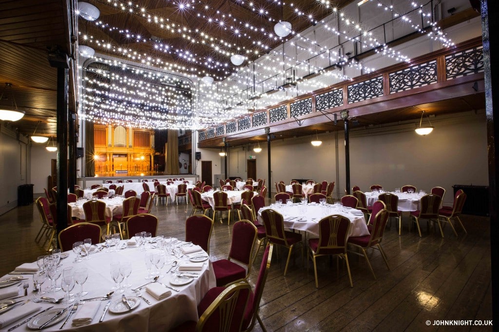 Prom venue decorated with red chairs and lots of small lights