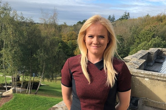 Courtney Smith standing on the balcony of salomons estate