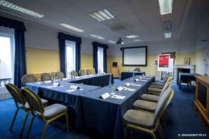 Room prepared for a corporate meeting with U shaped table