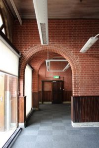 arch entrance to a room with an emergency exit