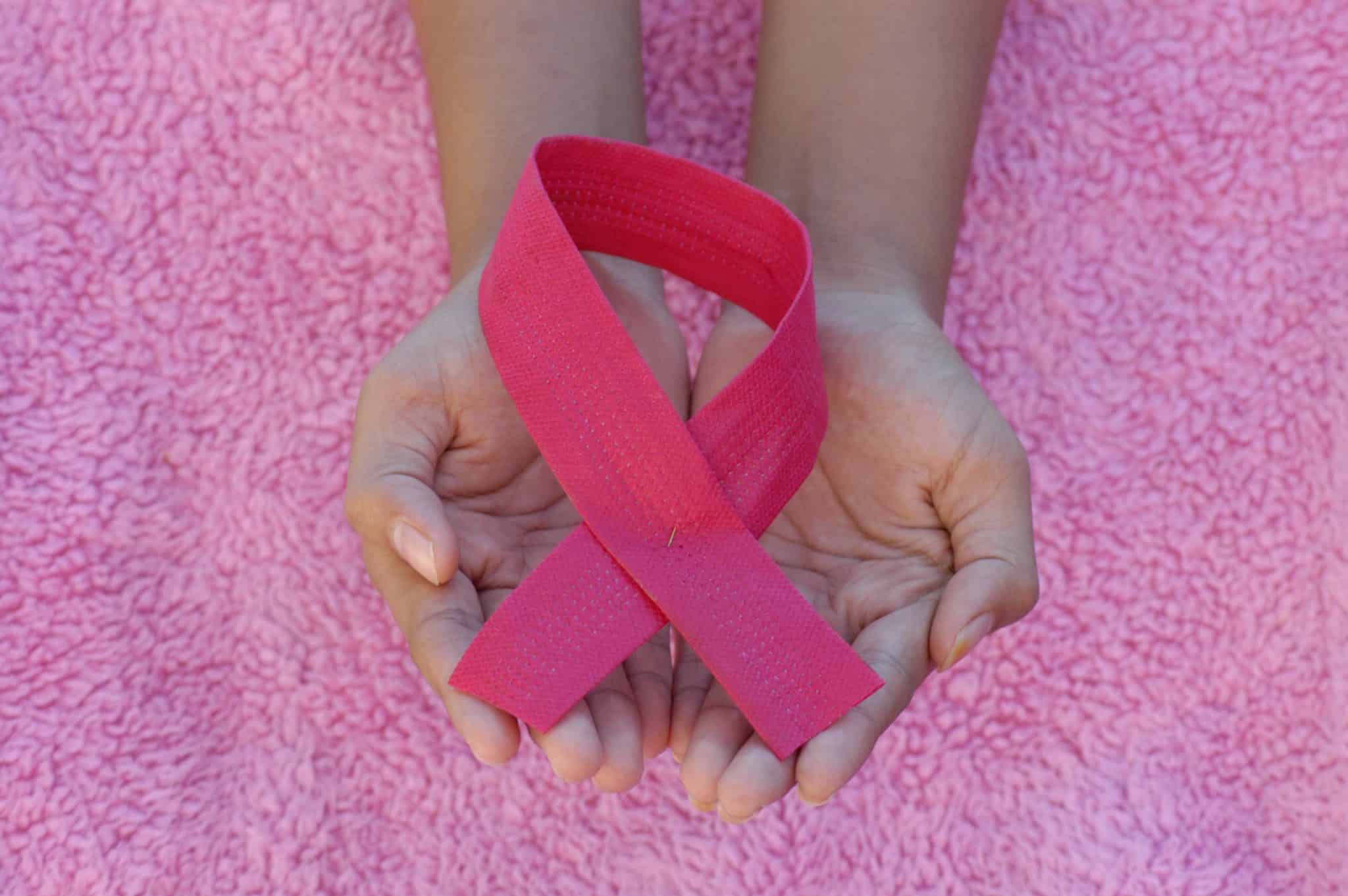 Hands holding a pink bow