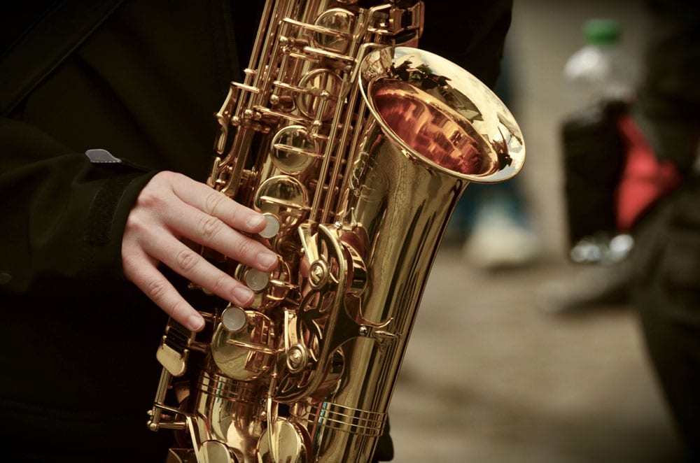 Close up of Saxophone being played by a person dressed in black
