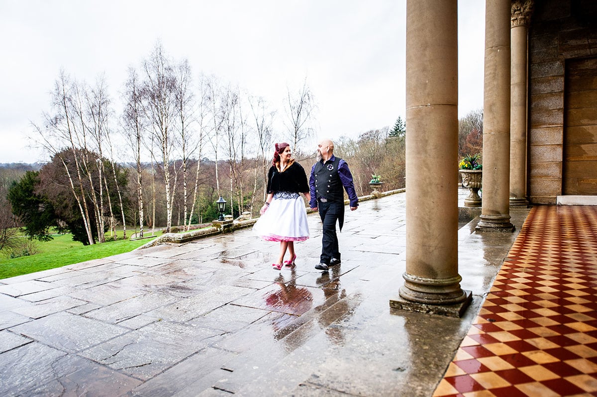 newly wed couple walking outside holding hands