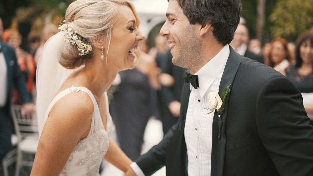 Couple laughing together at a wedding