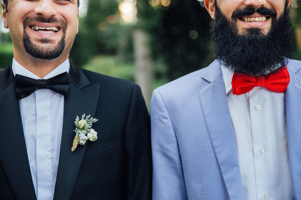 Two men in suits smiling