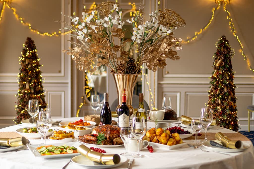 Fancy Table with Christmas lunch, wine and Christmas crackers