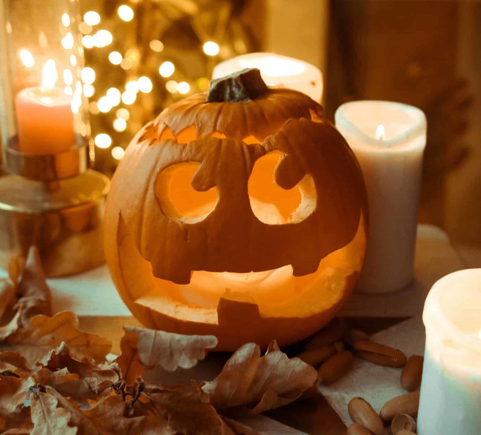 Carved Pumpkin surrounded by candles