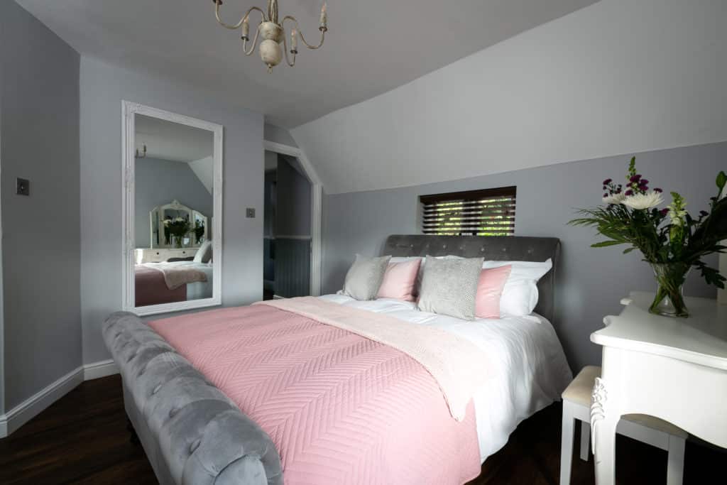 Double Bed with pink and grey sheets