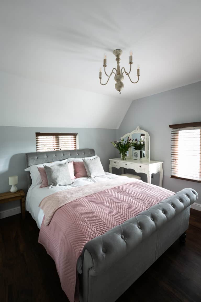 Double Bed with pink and grey sheets