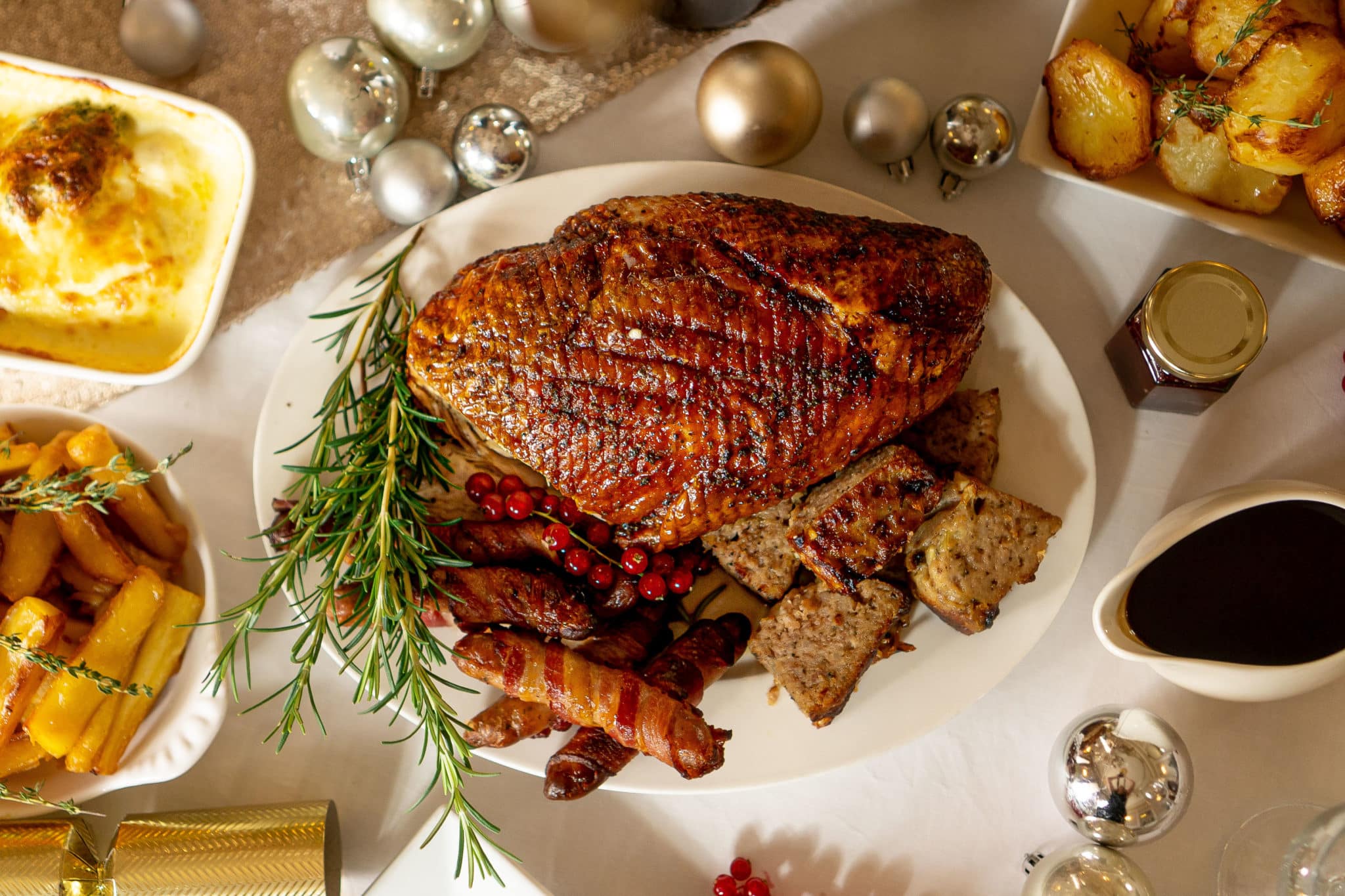 Christmas meal with roast turkey, pigs in blankets, crispy potatoes and gravy