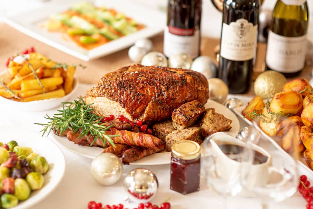a Christmas dinner spread with roast turkey, potatoes, veg and wine
