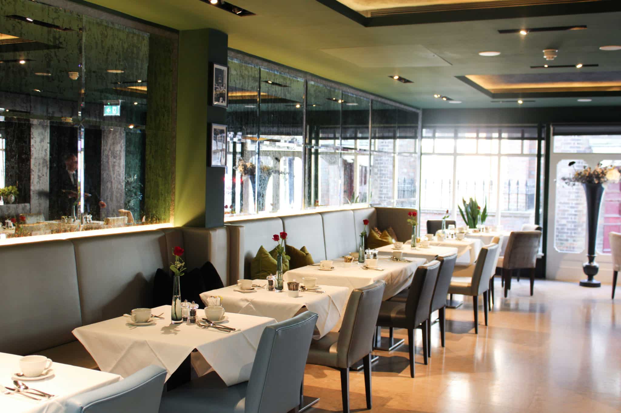 Dining area with tables decorated with red roses