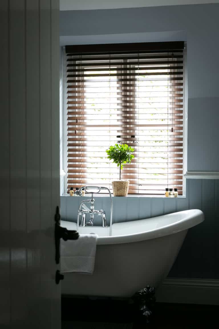 Open bathroom door with a bathtub inside