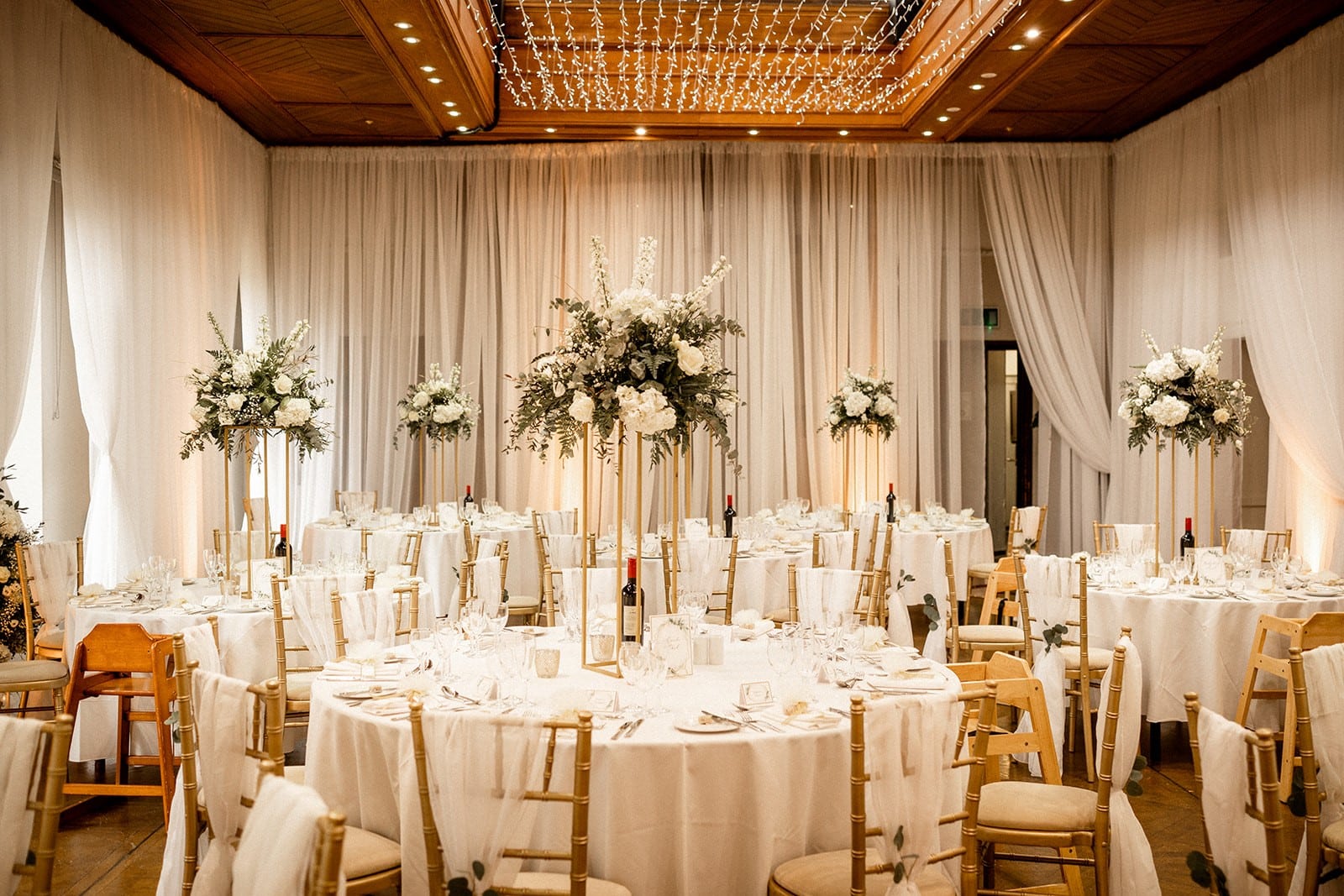 Set Wedding reception tables with tall flower bouquets