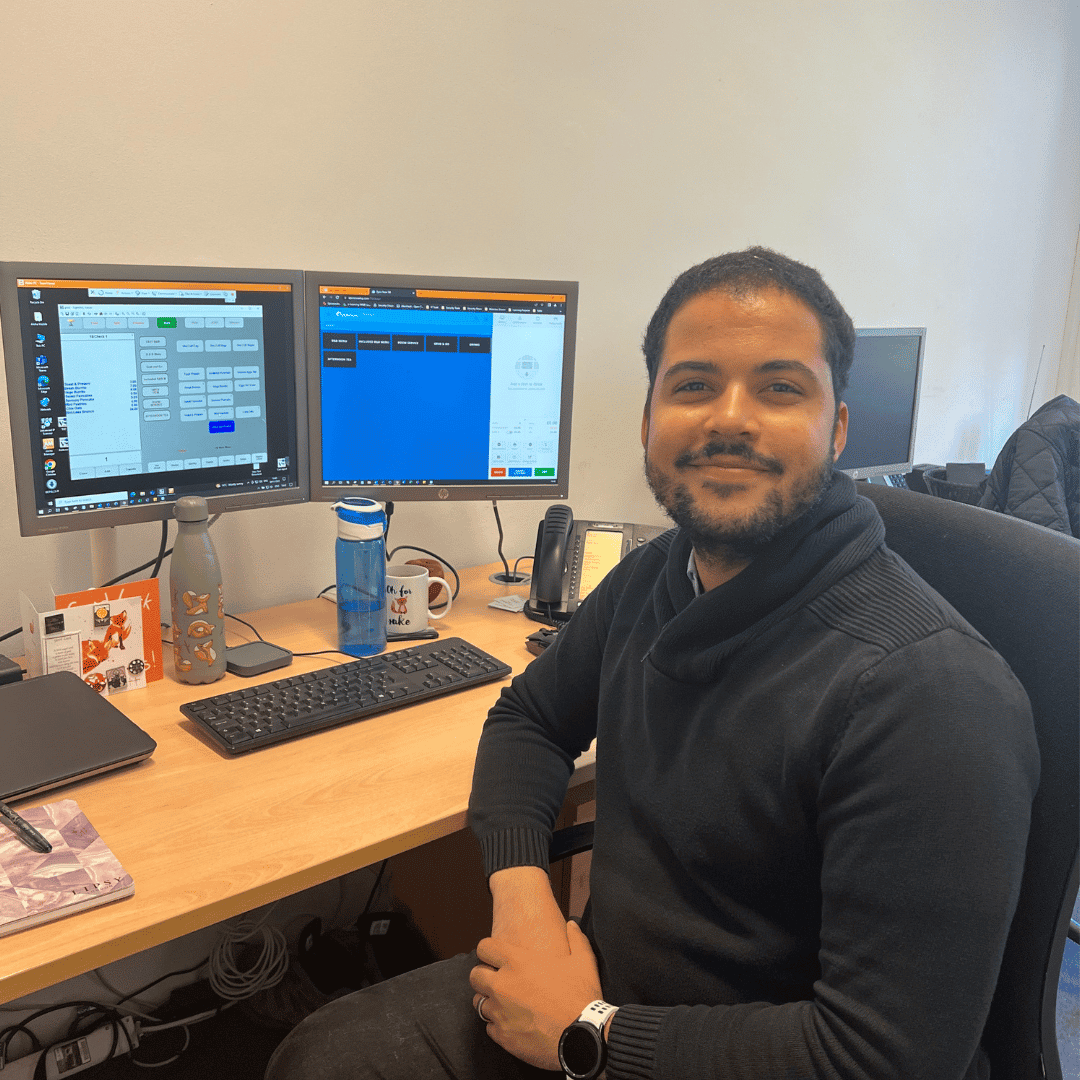 Man in front of two computer screens