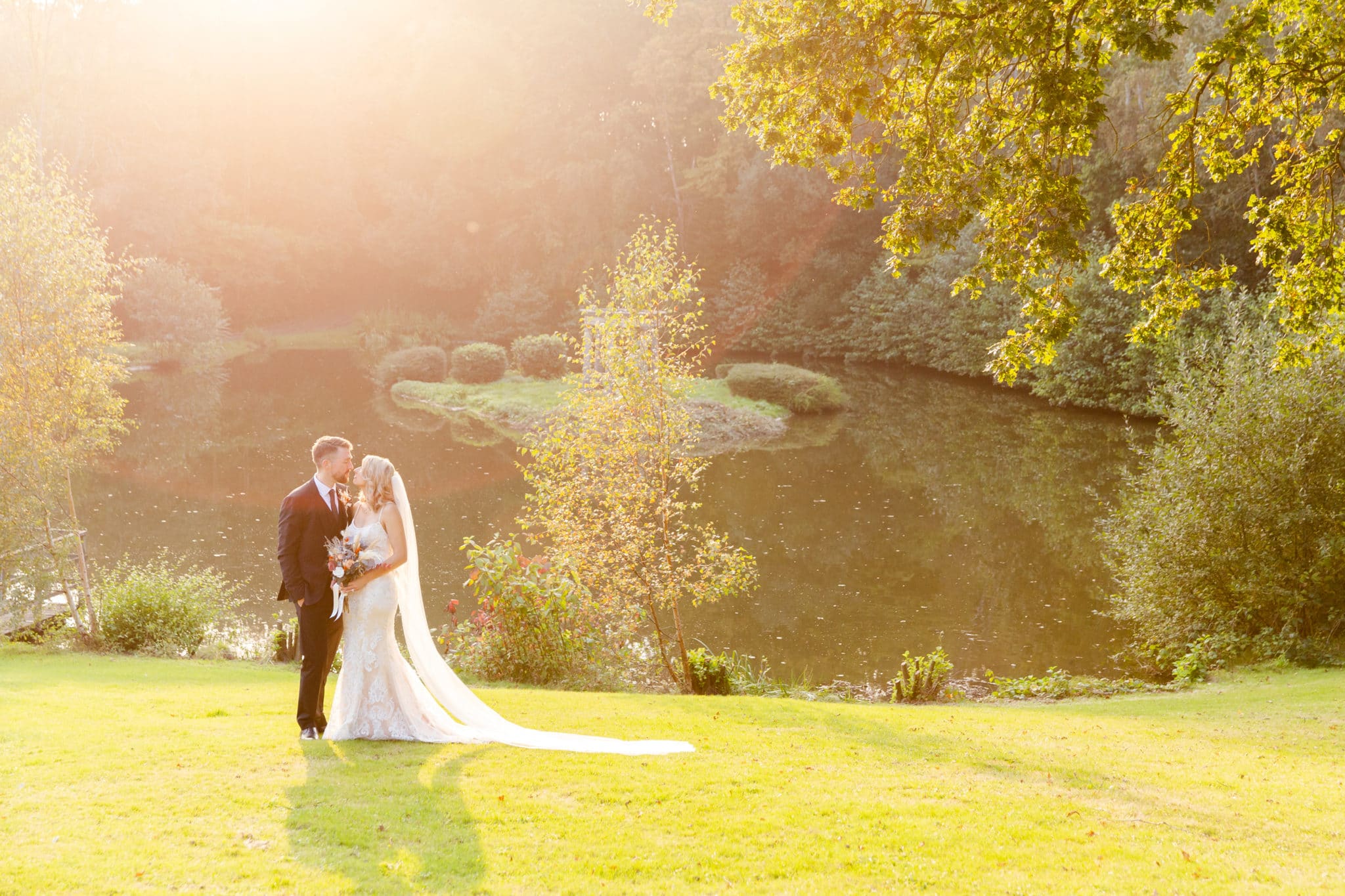 Recently Married Couple standing in front of a lake
