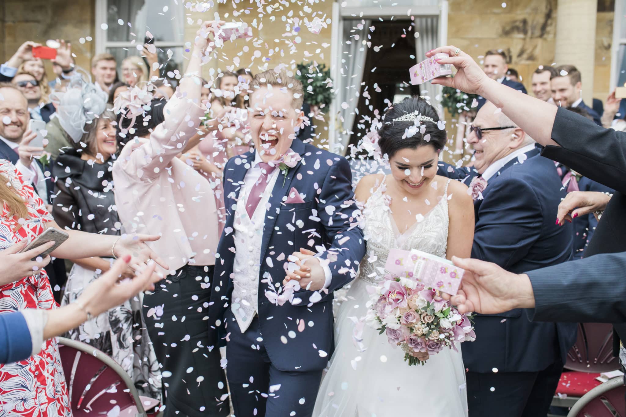 Bride and Groom getting confetti thrown at them