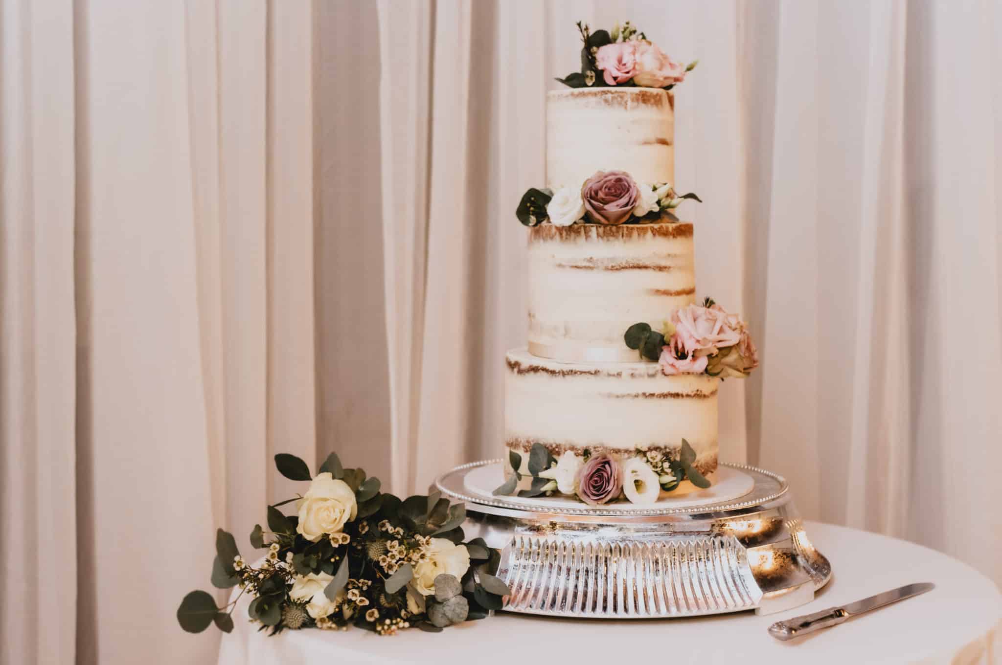 white wedding cake with flower decorations